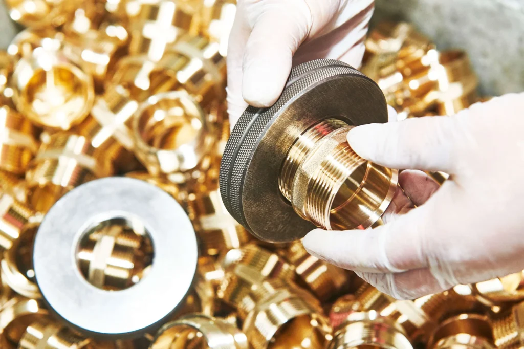 Close-up of hand holding brass fitting part