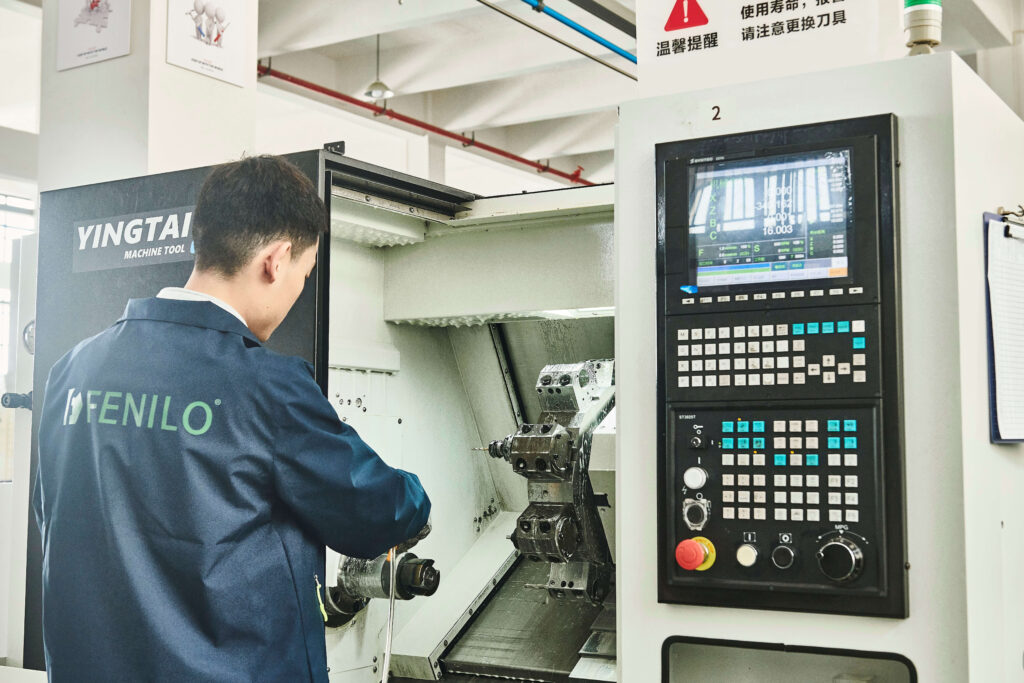 Factory worker operating a CNC machine